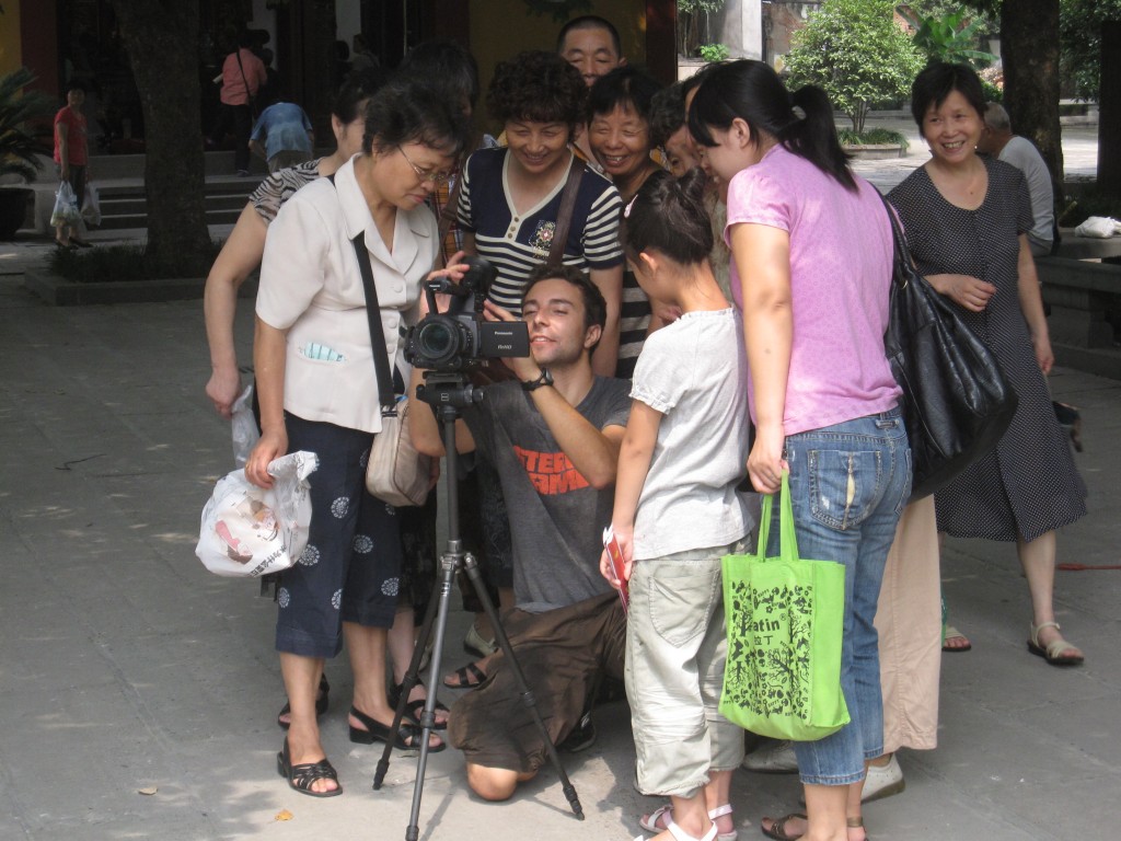 A crowd of Chinese gather around Brook Silva-Blaga's video camera in Hangzhou.